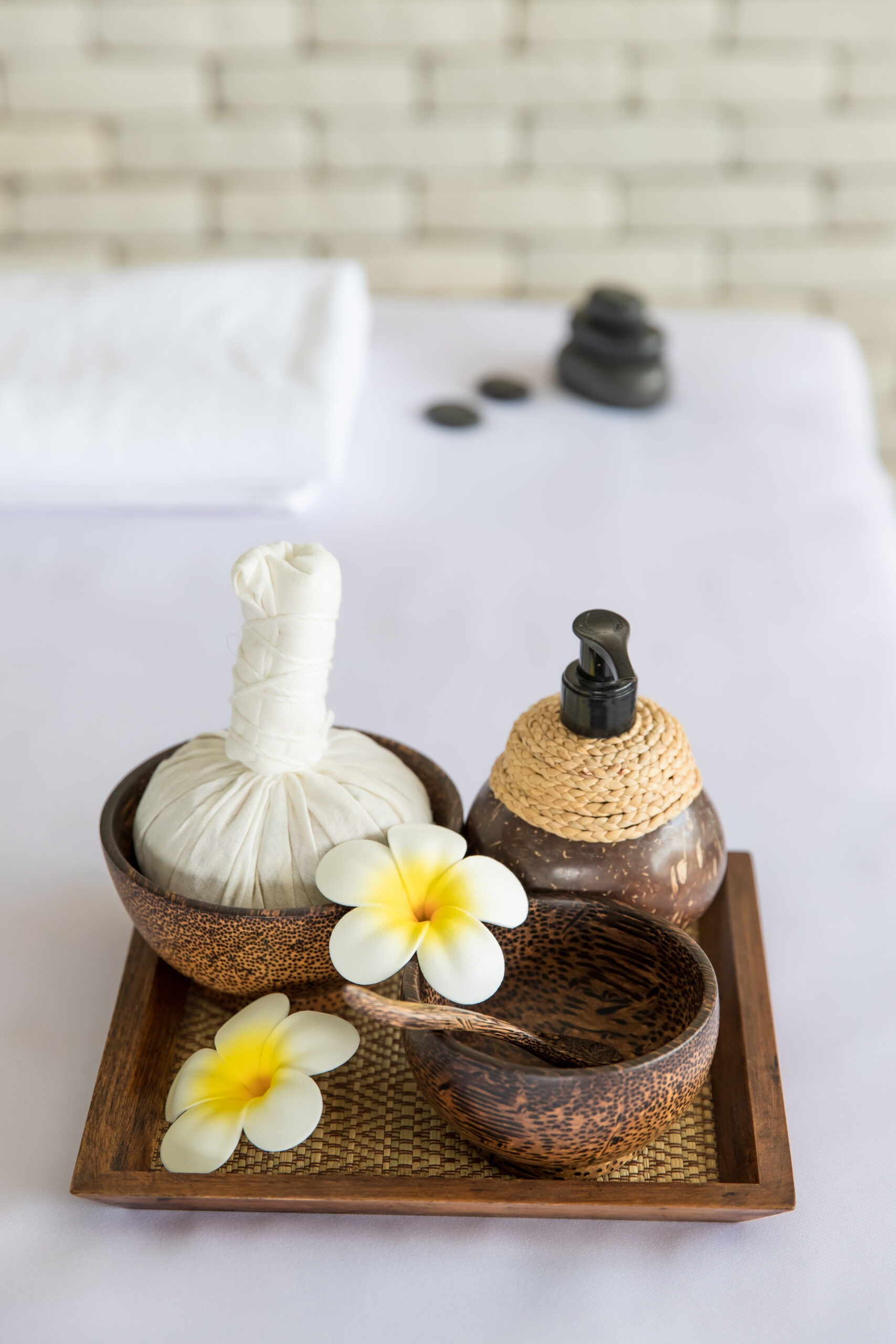 Closeup Shot Thai Massaging Stuffs Herbal Towel Compress Ball Coconut Oil Perfume Cosmetics Plumeria Flower Wooden Tray Placing Massage Bed Spa Therapy Preparing Customer Scaled